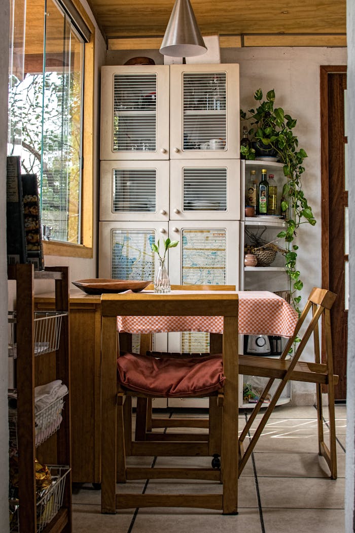 Home Warm and cozy kitchen featuring wooden furniture and green plants.