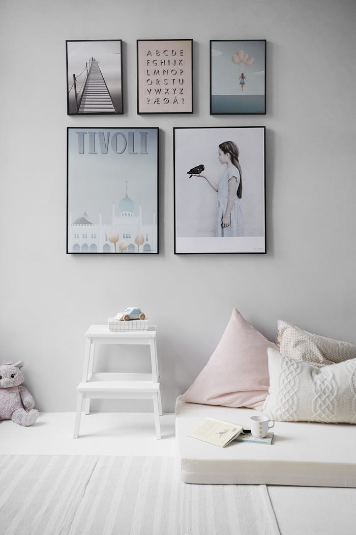 Services Minimalist Scandinavian bedroom with wall art and cozy decor elements.